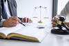 Legal professional with client, documents and gavel